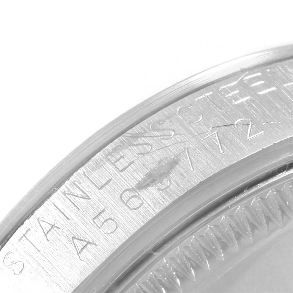This image shows a close-up view of the serial number engraving on the Mid-Size Rolex watch case.