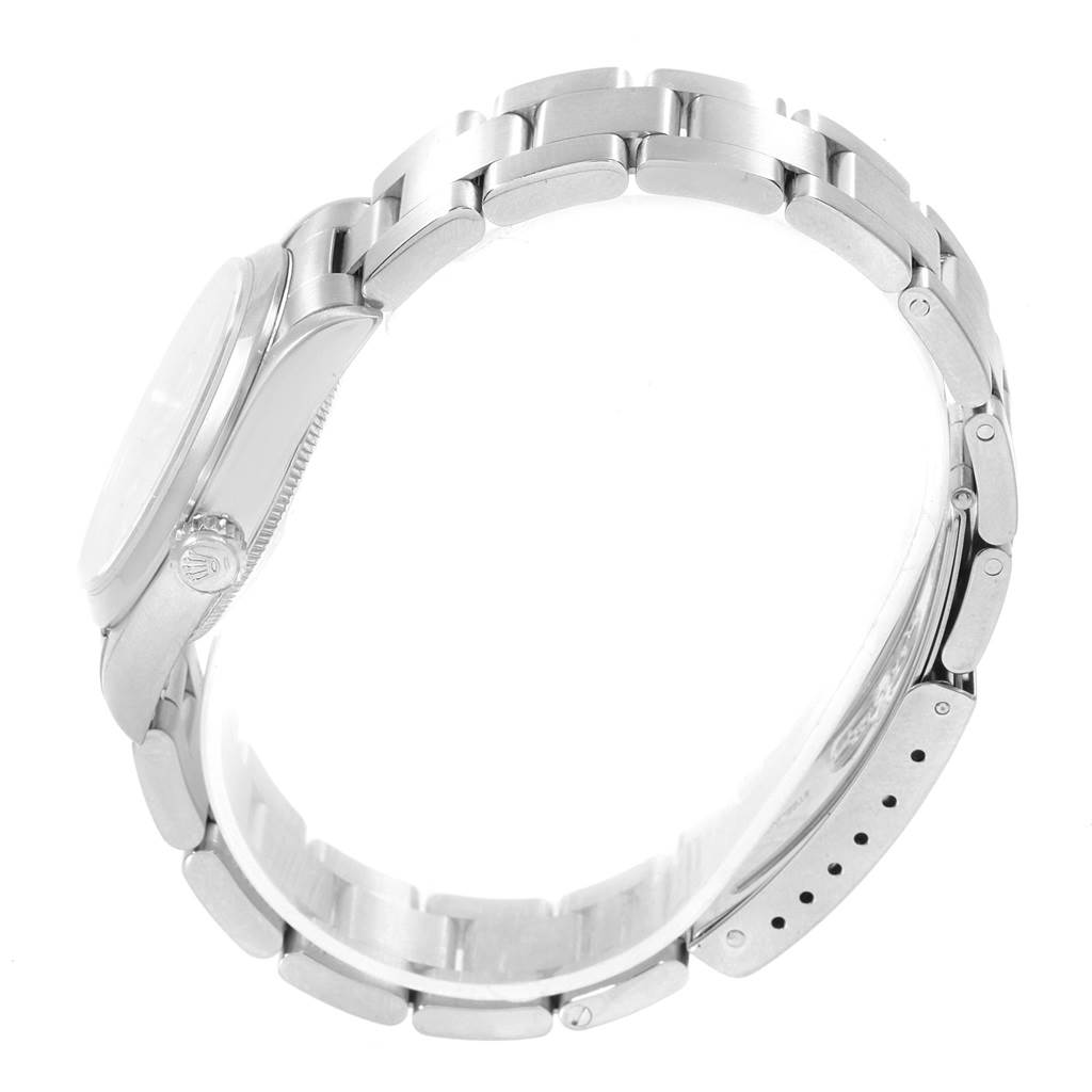 The image shows a side view of a Mid-Size Rolex watch, focusing on the case, crown, and metal bracelet.