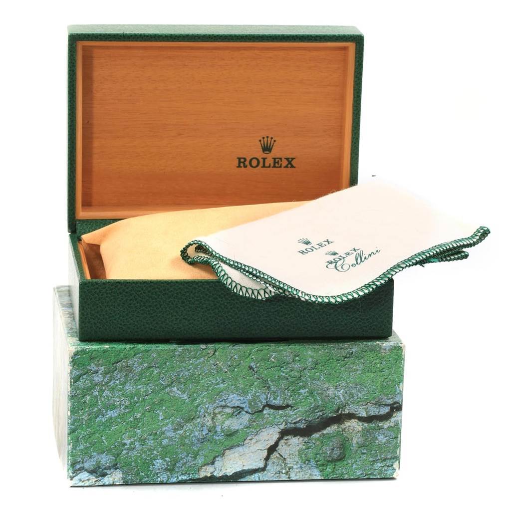 The image shows the open box and cleaning cloth accessories for a Rolex Mid-Size 77080 Women's Stainless Steel Silver Dial 77080 Women's Stainless Steel Silver Dial watch.