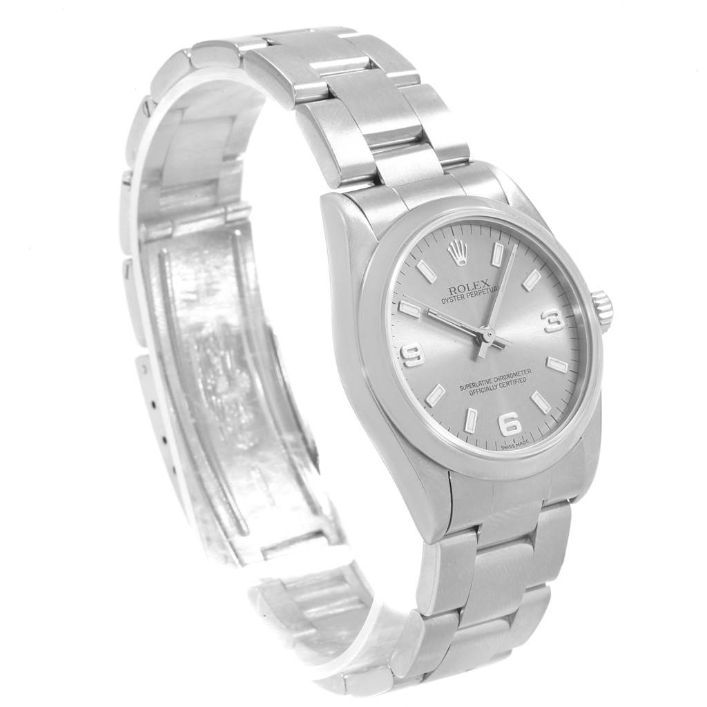 The image shows a Rolex Mid-Size 77080 Women's Stainless Steel Silver Dial 77080 Women's Stainless Steel Silver Dial watch at a front-side angle, displaying its face, bezel, and partially open stainless steel bracelet.