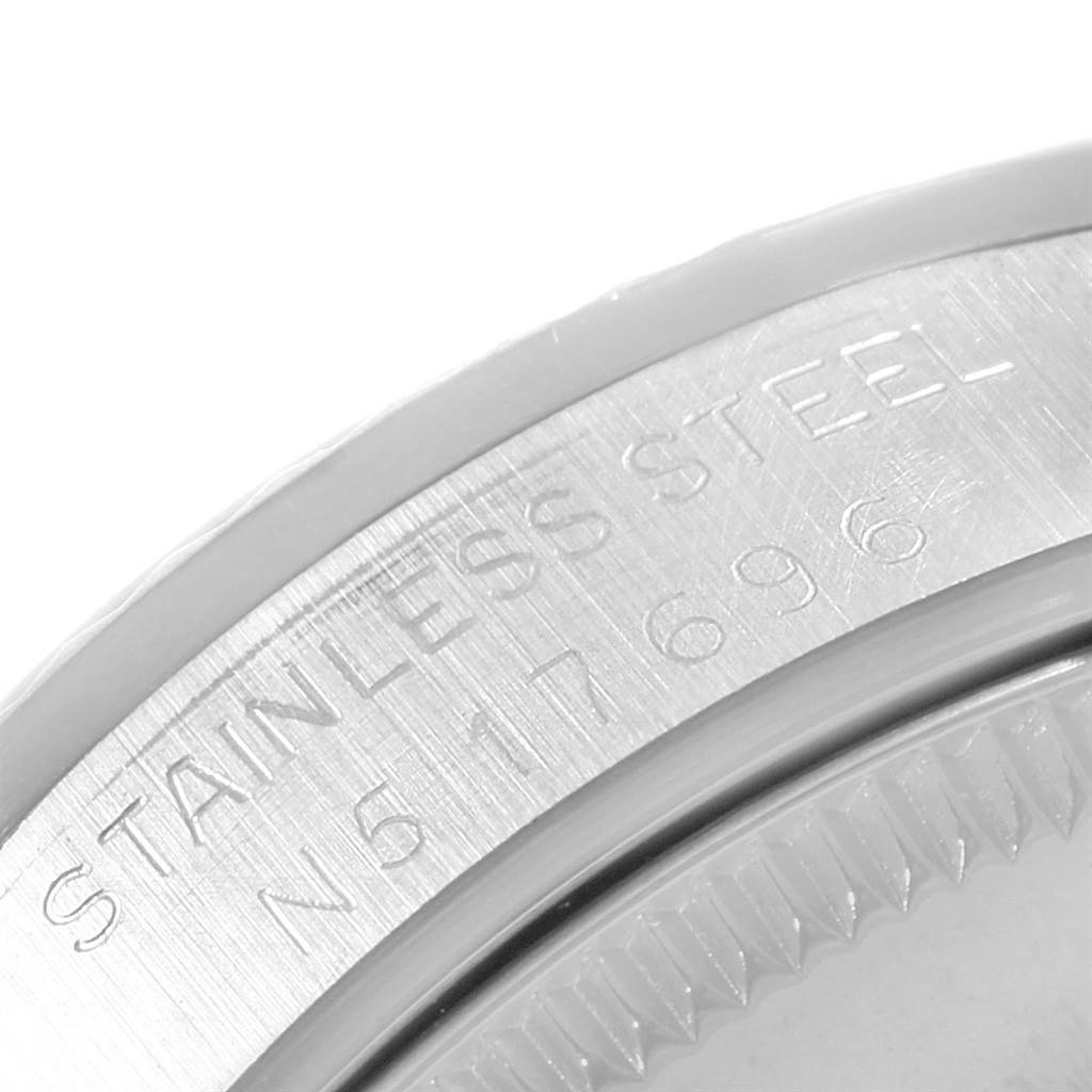 This image shows the side view of the case back of a Rolex Mid-Size 68274 Women
s Stainless Steel Black Dial 68274 Women
s Stainless Steel Black Dial model, with "Stainless Steel" and serial number engravings.