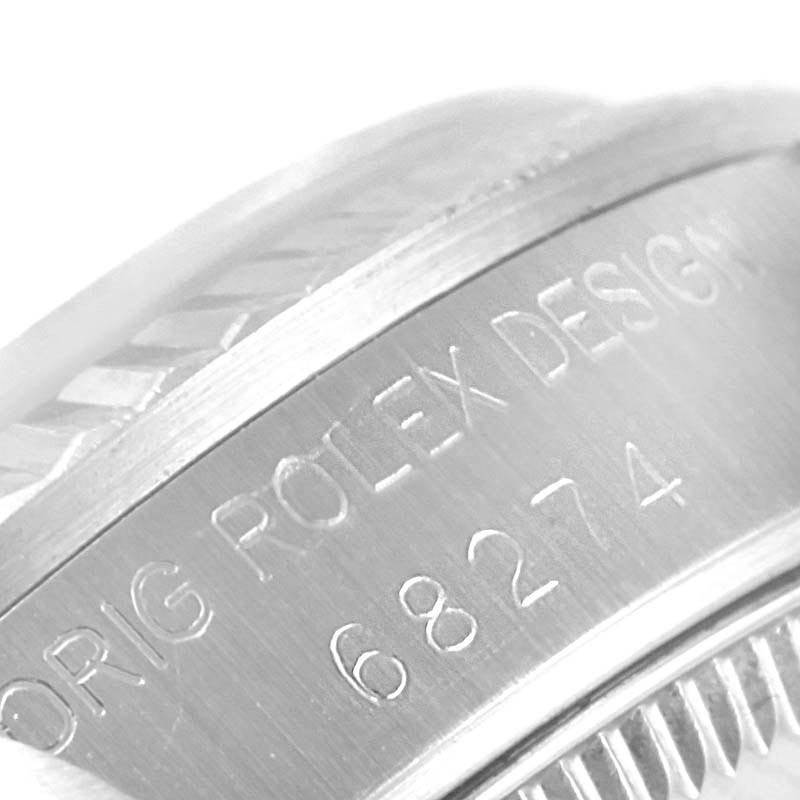 This close-up image shows the edge of the casing for the Rolex Mid-Size 68274 Women
s Stainless Steel Black Dial 68274 Women
s Stainless Steel Black Dial model, highlighting the engraved model number "68274".