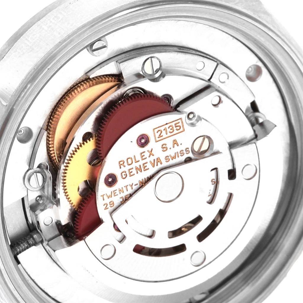 The image shows the internal mechanism of a Rolex Mid-Size 68274 Women
s Stainless Steel Black Dial 68274 Women
s Stainless Steel Black Dial model watch, including gears and the balance wheel, viewed from the rear.