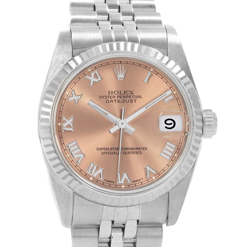 The image shows a front view of a Rolex Mid-Size 68274 Women's Stainless Steel Pink Dial 68274 Women's Stainless Steel Pink Dial Datejust watch, featuring a silver bracelet, a fluted bezel, and a pink dial with Roman numerals.