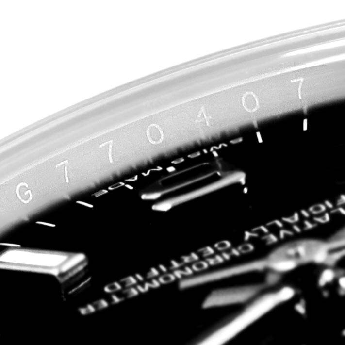 The close-up angle of this Rolex Mid-Size 177200 Women's Stainless Steel Black Dial 177200 Women's Stainless Steel Black Dial model shows part of the watch's face and the engraved serial number on the inner bezel.