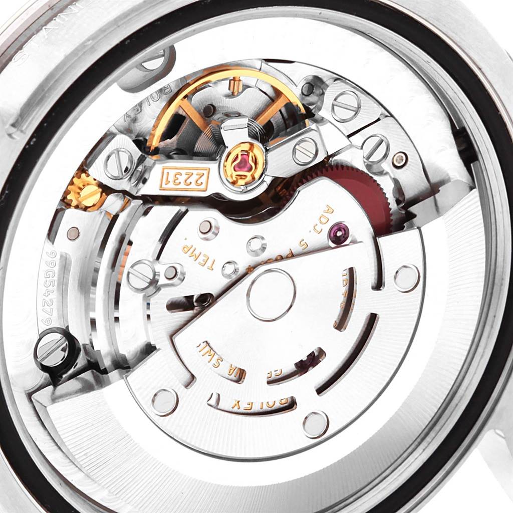 A mid-size Rolex watch's movement and inner mechanism are shown from a close-up rear angle.