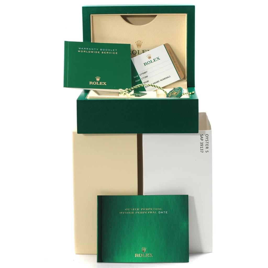 The image shows the box, warranty booklet, and other documentation for a Mid-Size Rolex watch.