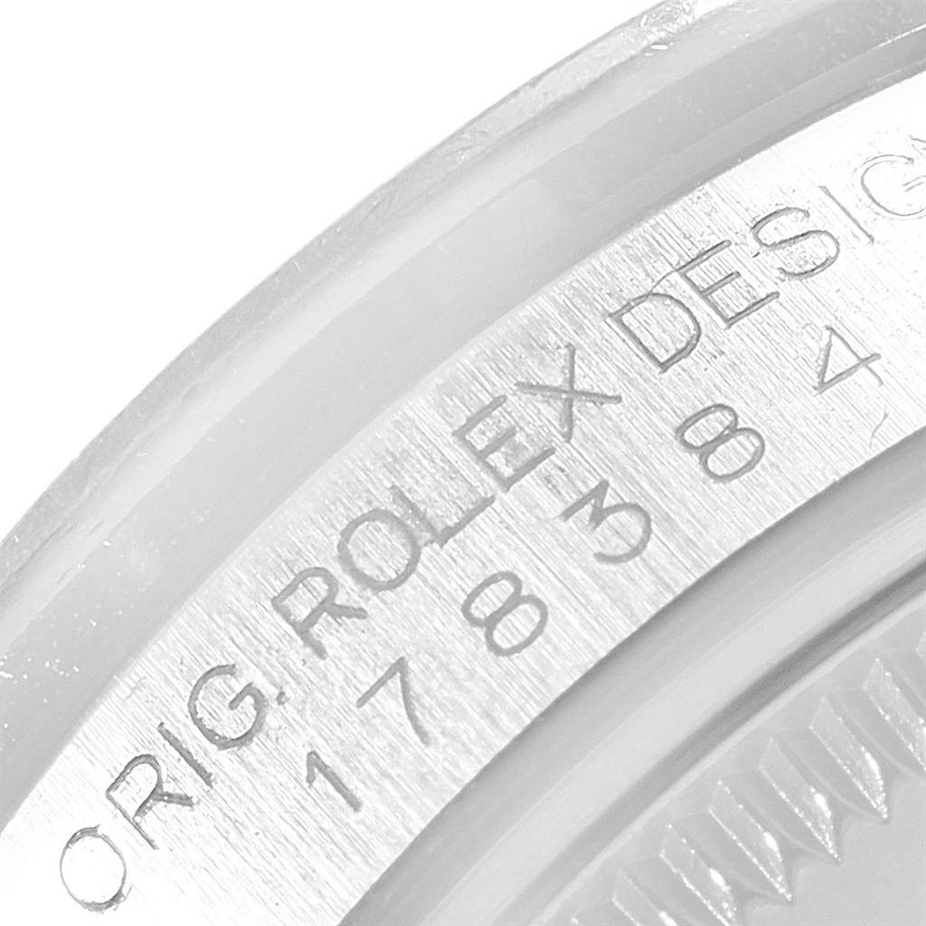 The image shows a close-up of the side engraving on a Mid-Size Rolex watch bezel.