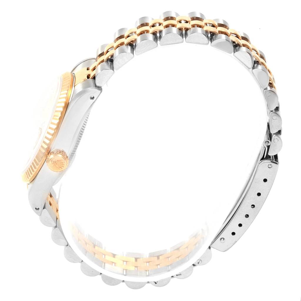 The image shows a side view of a Rolex Mid-Size 68273 Women
s Steel and Gold (two tone) Champagne Dial 68273 Women
s Steel and Gold (two tone) Champagne Dial model watch, focusing on the case, bezel, crown, and part of the bracelet.