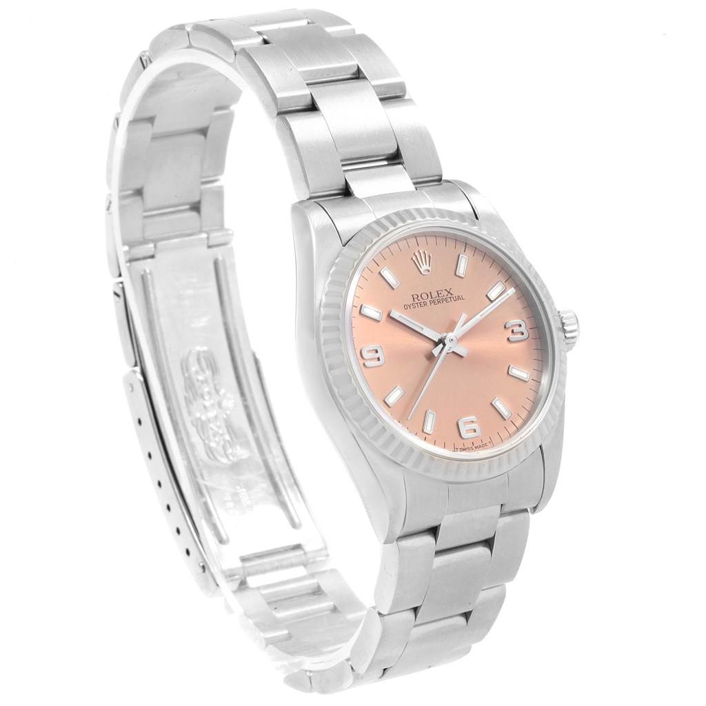 The Rolex Mid-Size 67514 Women
s Stainless Steel Pink Dial 67514 Women
s Stainless Steel Pink Dial watch is shown at an angled view, displaying the dial, bezel, and bracelet with an open clasp.