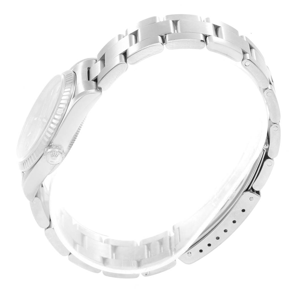 The image shows a side view of a Rolex Mid-Size 67514 Women
s Stainless Steel Pink Dial 67514 Women
s Stainless Steel Pink Dial watch, focusing on the bracelet, crown, and case.