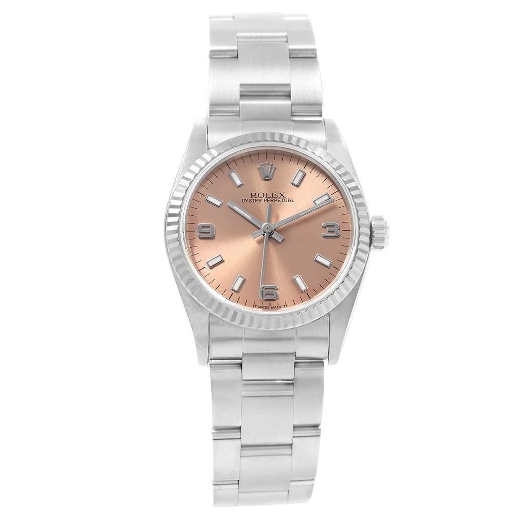 The image shows a Rolex Mid-Size 67514 Women
s Stainless Steel Pink Dial 67514 Women
s Stainless Steel Pink Dial Oyster Perpetual watch from a top-down angle, displaying the face and bracelet.