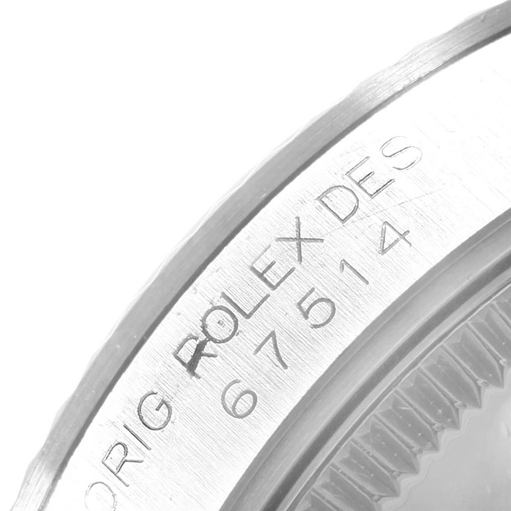 This image shows a close-up of the case back edge with the engraved model number of a Mid-Size Rolex watch.