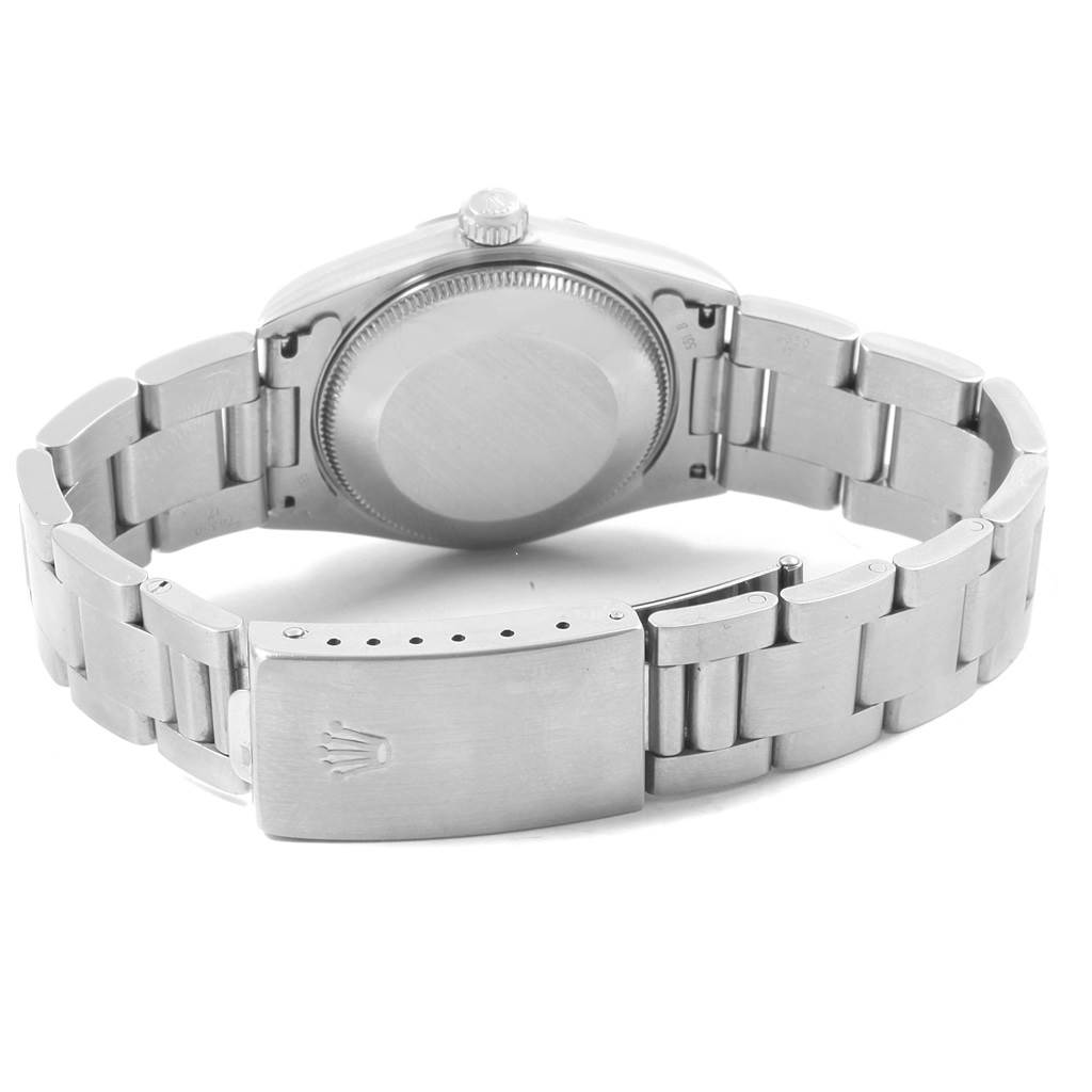 The image shows the back and bracelet of a mid-size Rolex watch, including the clasp and case back.