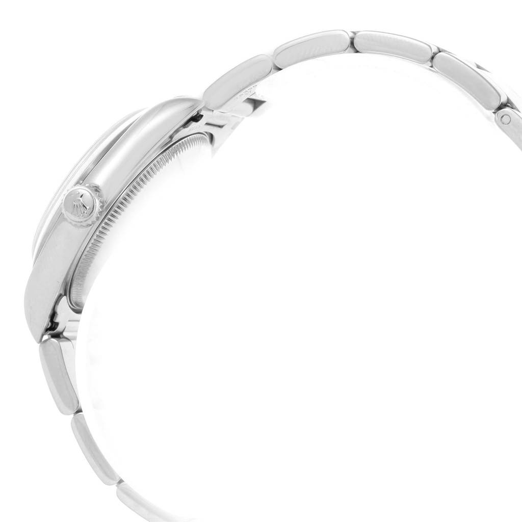 This side view of the Rolex Mid-Size 77080 Women's Stainless Steel Black Dial 77080 Women's Stainless Steel Black Dial watch shows the case, crown, and part of the bracelet.