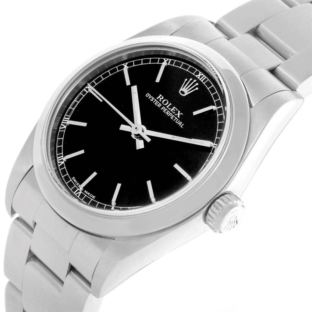 The image shows a Rolex Mid-Size 77080 Women's Stainless Steel Black Dial 77080 Women's Stainless Steel Black Dial Oyster Perpetual watch, featuring the dial, hands, bezel, and part of the bracelet at an angled view.