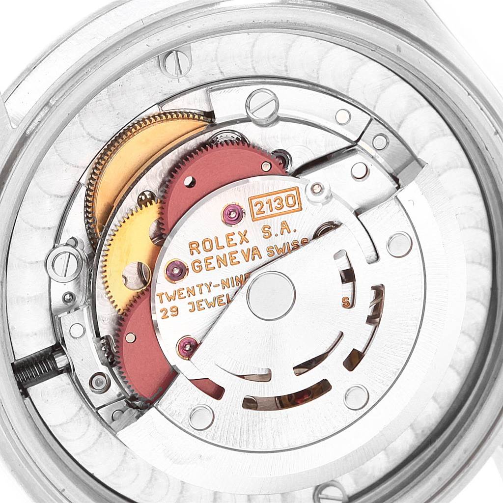 This image shows the internal movement and components of a Mid-Size Rolex watch from a back view angle.