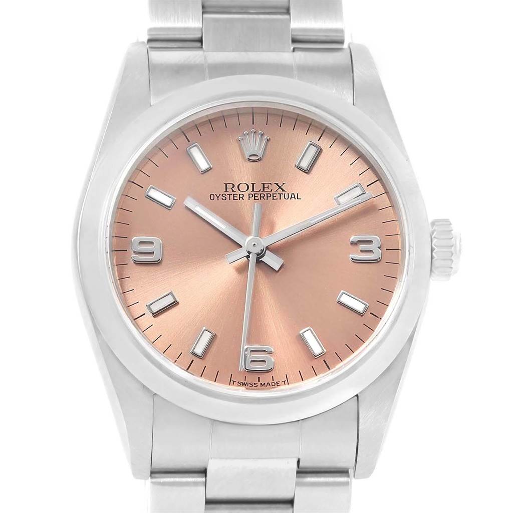 The image shows a front view of a Mid-Size Rolex Oyster Perpetual watch with a silver bracelet and a salmon-colored dial.