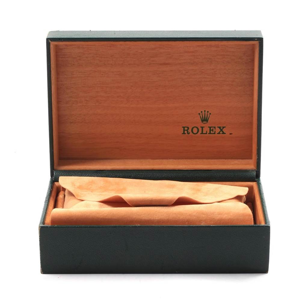 The image shows an open green Rolex watch box with a tan interior, but no watch is visible inside.