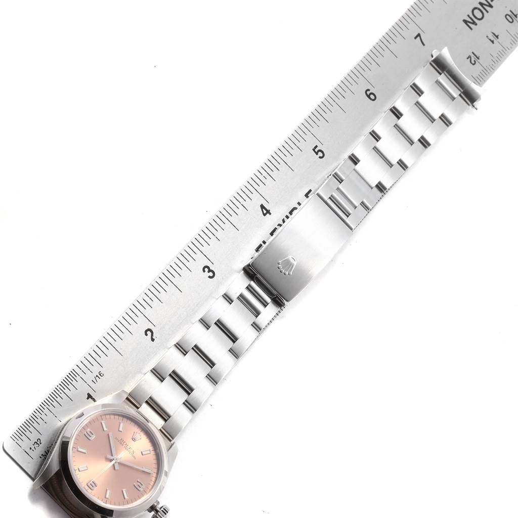 The image shows a Rolex Mid-Size 67480 Women's Stainless Steel Pink Dial 67480 Women's Stainless Steel Pink Dial model watch, including its face, bracelet, and clasp, measured against a ruler.