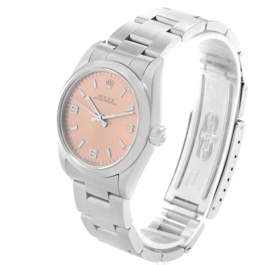 This Rolex Mid-Size 67480 Women's Stainless Steel Pink Dial 67480 Women's Stainless Steel Pink Dial Oyster Perpetual watch is shown from a three-quarter angle, displaying the dial, bezel, and partially open bracelet.
