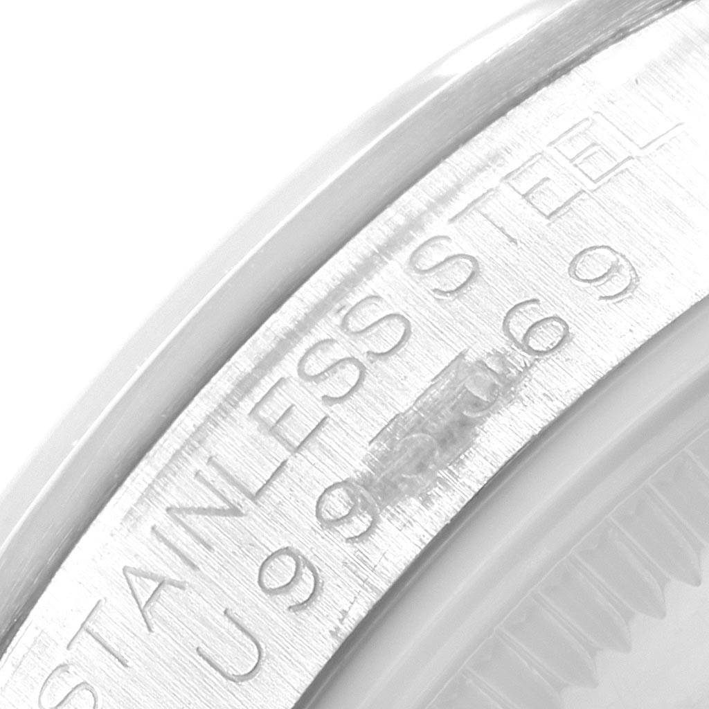 The image shows a close-up of the engravings on the inner bezel of a Rolex Mid-Size 67480 Women's Stainless Steel Pink Dial 67480 Women's Stainless Steel Pink Dial watch.