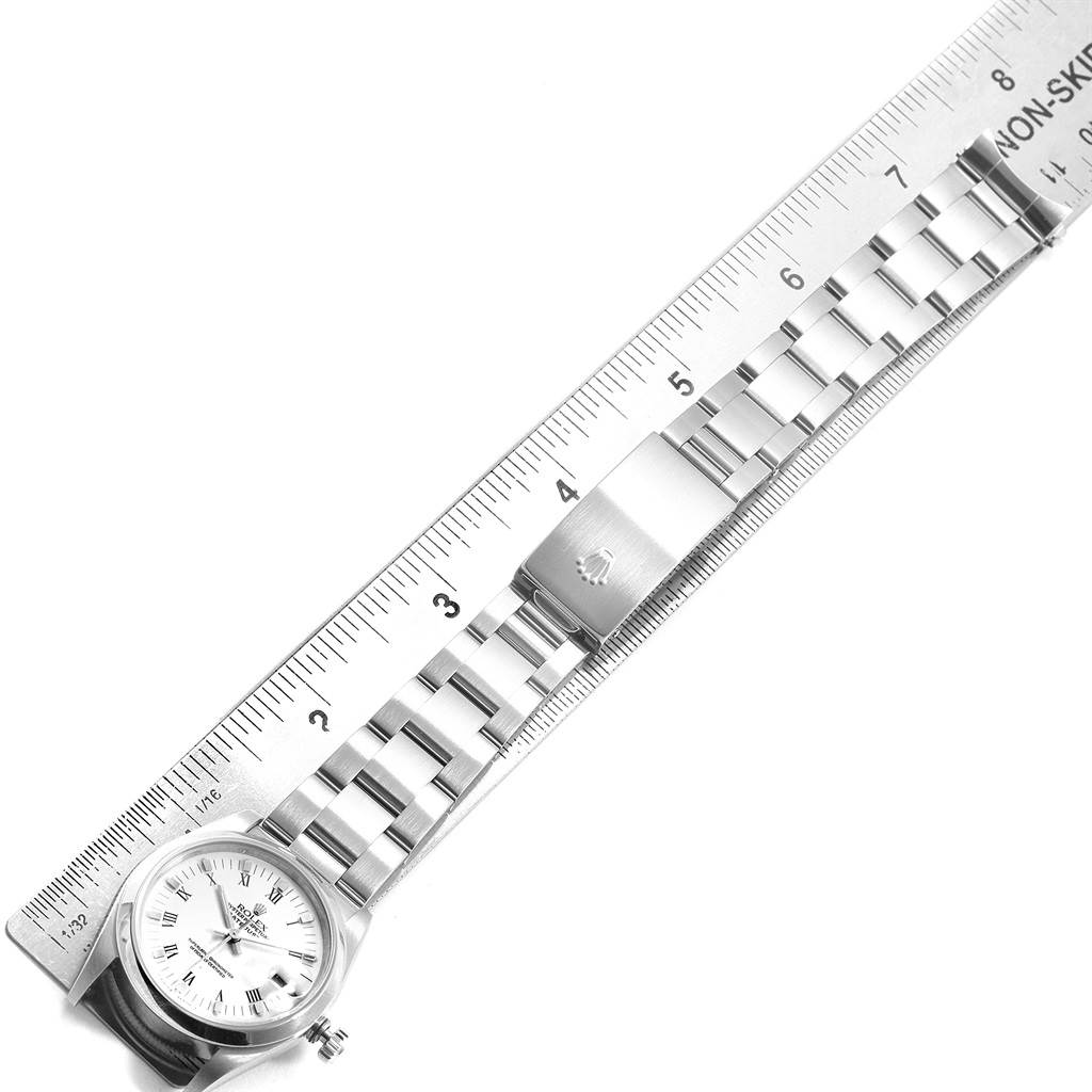 A Rolex Mid-Size 68240 Women's Stainless Steel White Dial 68240 Women's Stainless Steel White Dial watch is shown from the side with a ruler measuring its length.