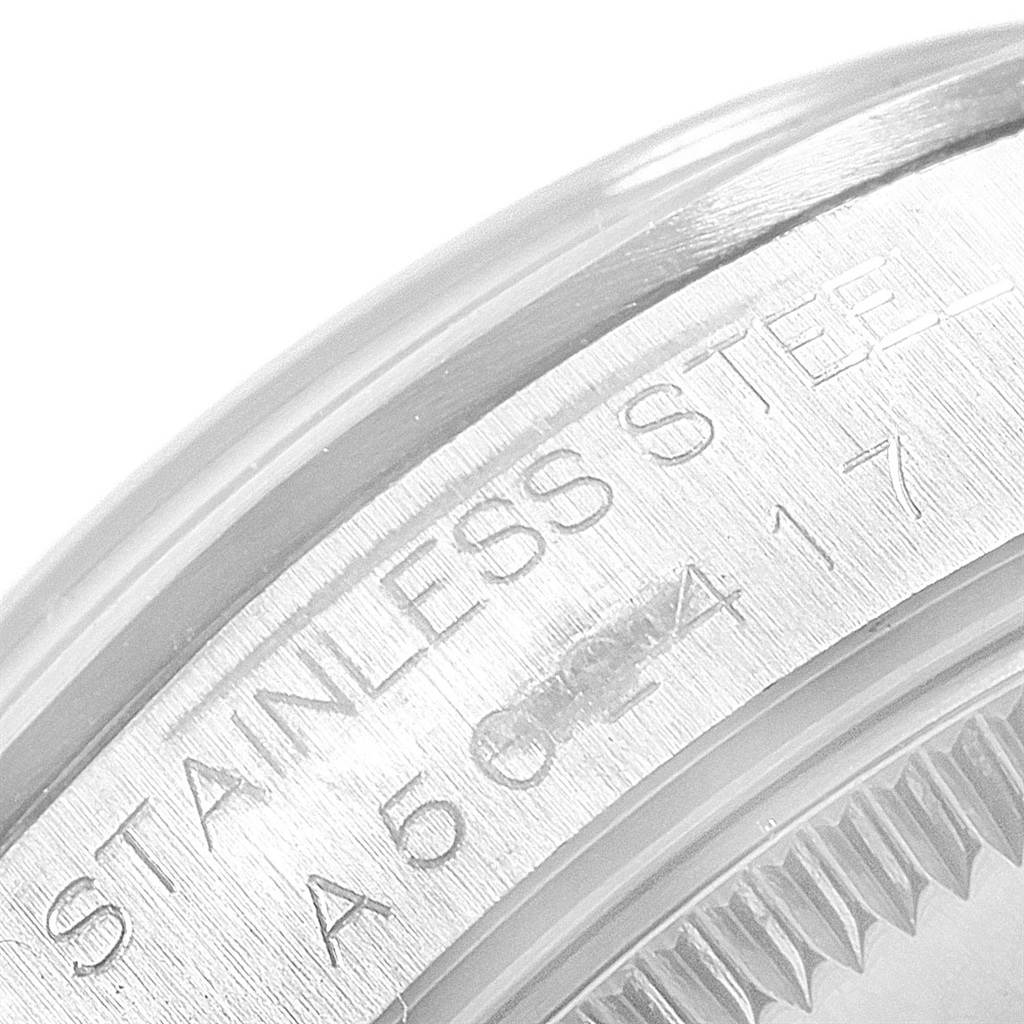 The image shows a close-up of the case back and engravings of a Mid-Size Rolex watch from a side angle.