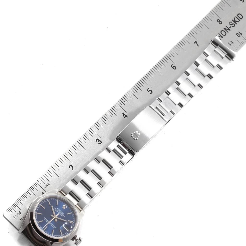The image shows a Mid-Size Rolex watch and its stainless steel bracelet, measured alongside a ruler.