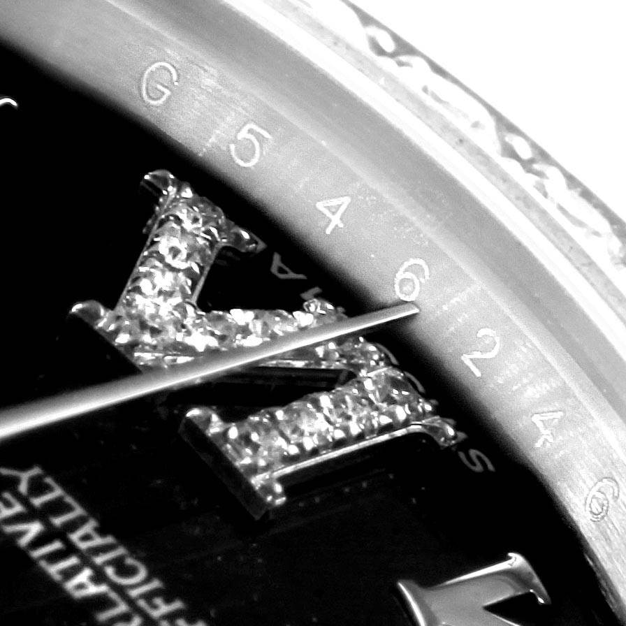This is a close-up angle of a Rolex Mid-Size 178384 Women's Stainless Steel Black Dial 178384 Women's Stainless Steel Black Dial watch showing part of the dial and diamond-set markers.