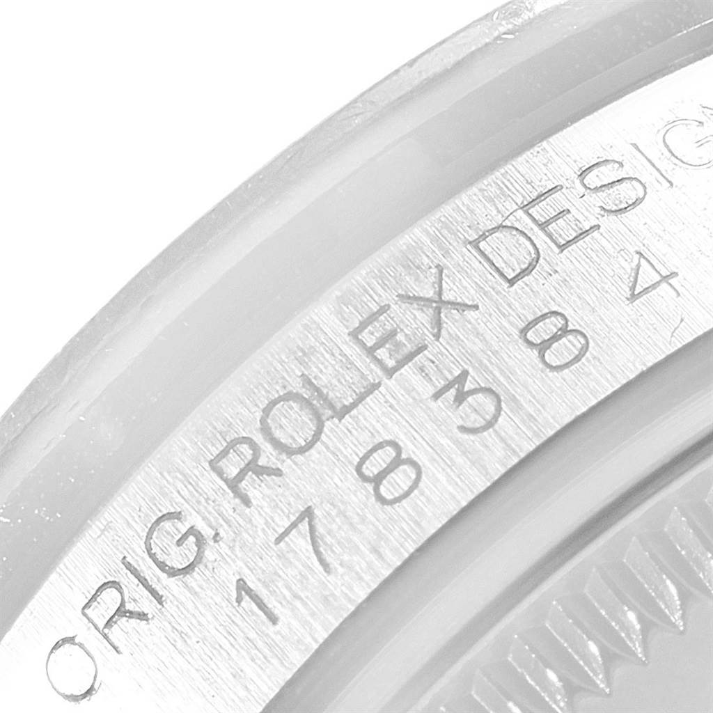 The image shows a close-up of the case back engraving on a Mid-Size Rolex watch.