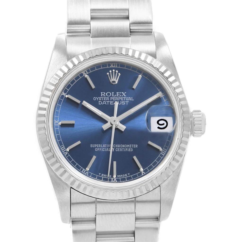 The image shows a front view of the Rolex Mid-Size 68274 Women's Stainless Steel Blue Dial 68274 Women's Stainless Steel Blue Dial Datejust watch, highlighting its blue dial, fluted bezel, and bracelet.