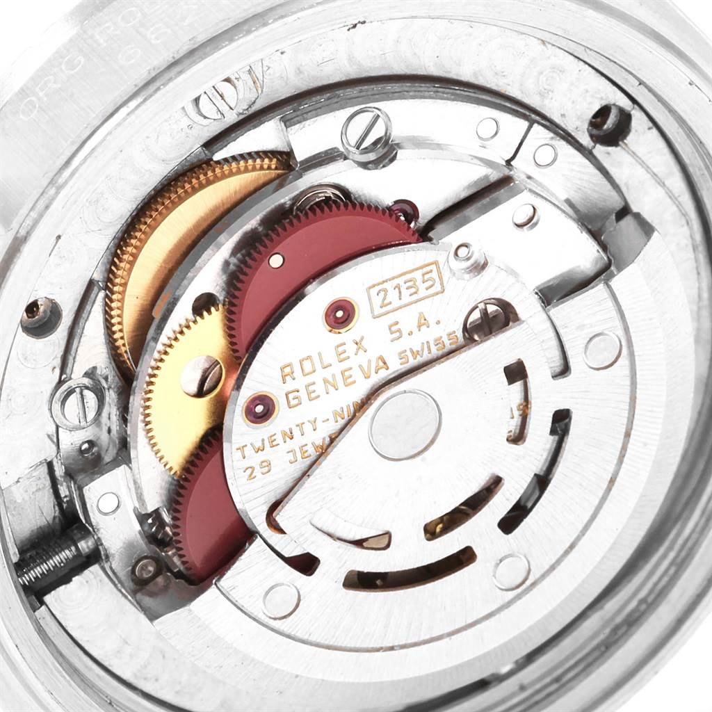 The image shows a close-up of the internal movement mechanism of a mid-size Rolex watch, model 2135.
