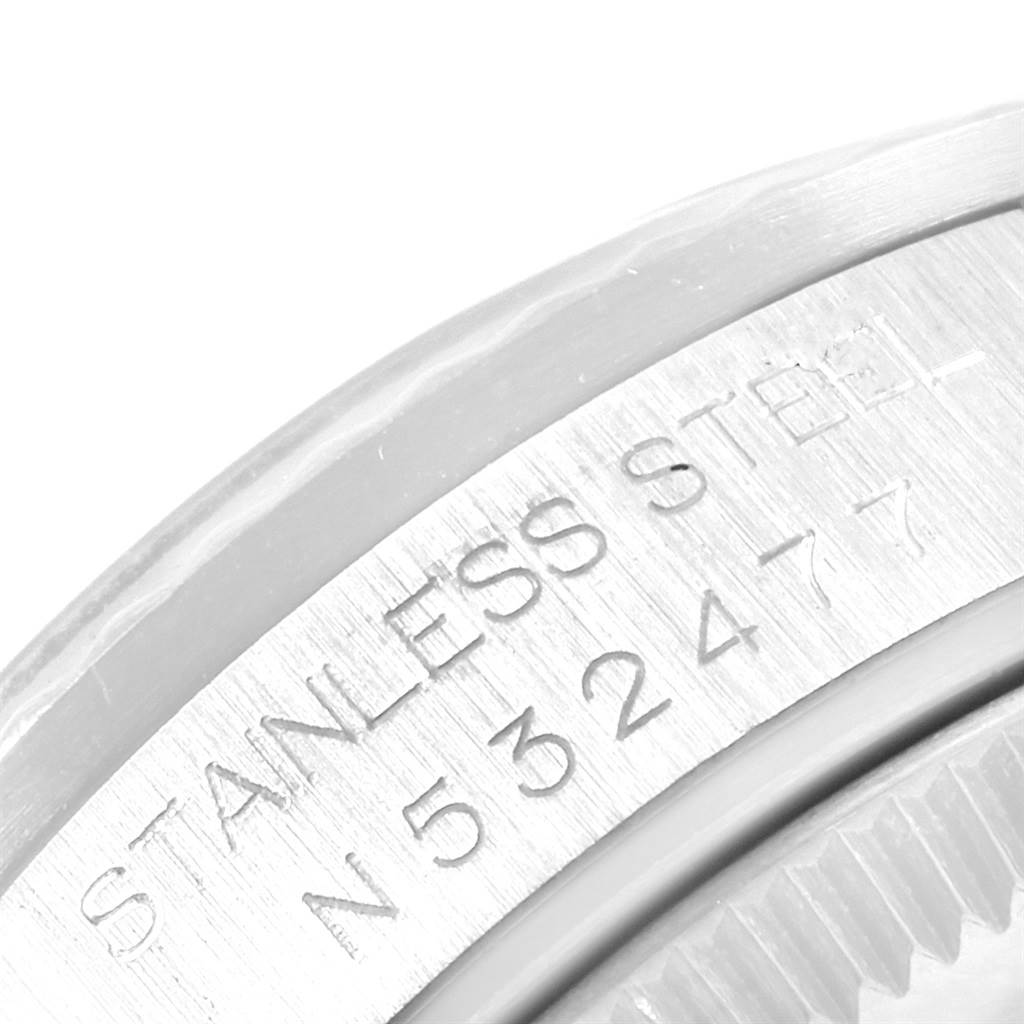 The image shows the close-up of a serial number and the “STAINLESS STEEL” engraving on a Rolex Mid-Size 68274 Women's Stainless Steel Blue Dial 68274 Women's Stainless Steel Blue Dial model.