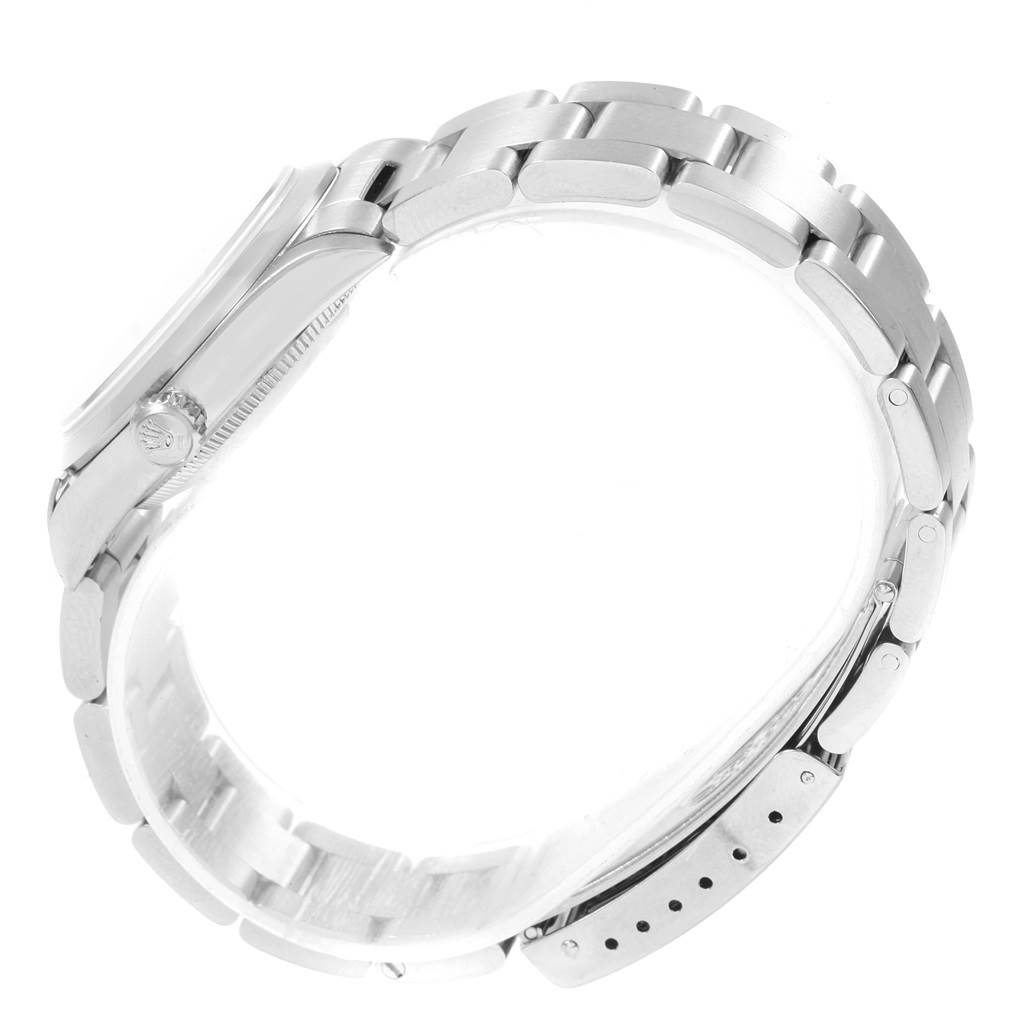 The image shows a side profile of a Mid-Size Rolex watch, focusing on the bracelet, clasp, and the side of the case with the crown.