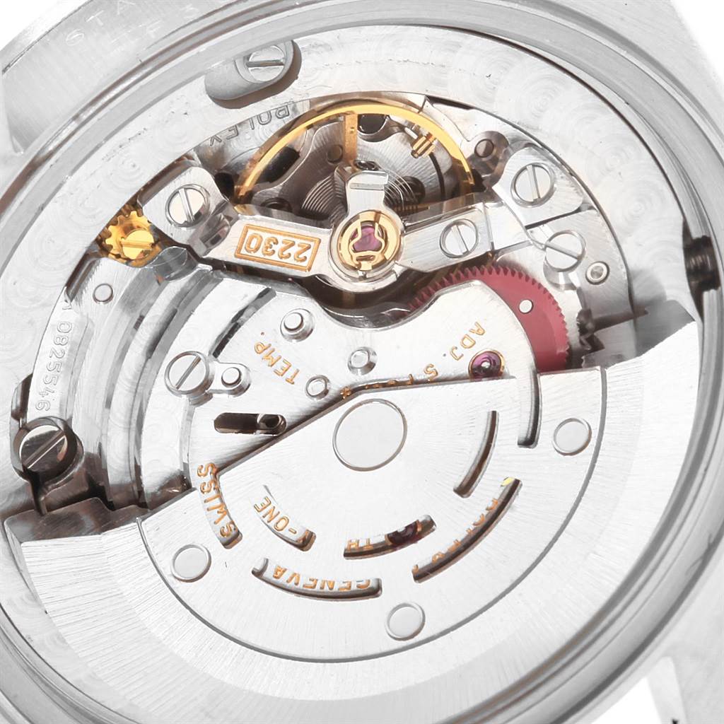 The image shows the internal movement mechanism of a Mid-Size Rolex watch, emphasizing gears and components from a close-up angle.