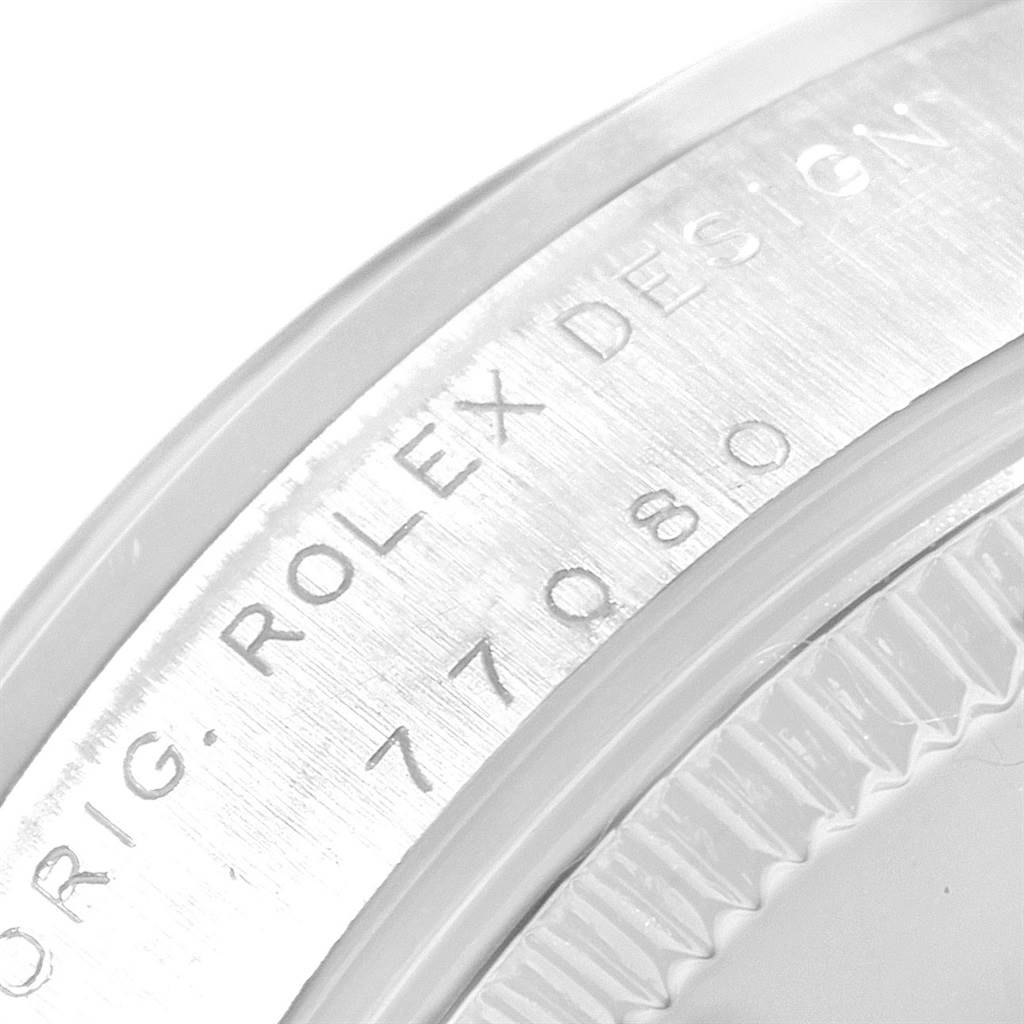 The image shows a close-up of the case back and engraved serial number on a Mid-Size Rolex watch.