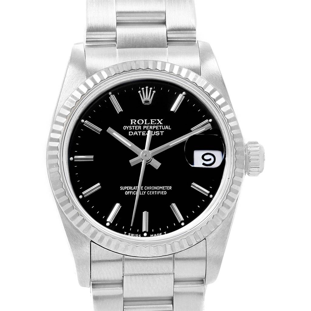 The image shows a front view of a Rolex Mid-Size 68274 Women's Stainless Steel Black Dial 68274 Women's Stainless Steel Black Dial Datejust watch, highlighting its black dial, fluted bezel, and date aperture.