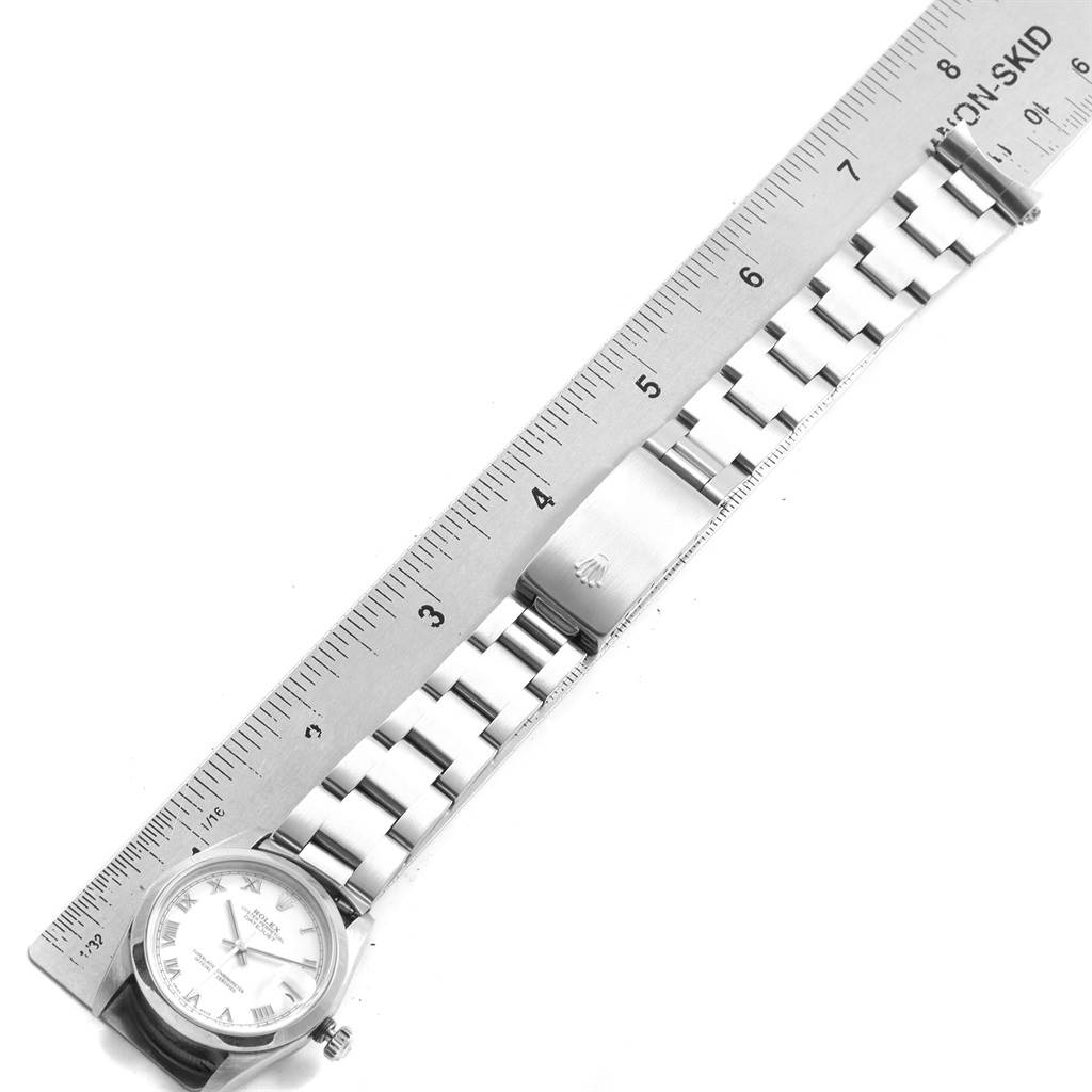 The image shows a Rolex Mid-Size 78240 Women's Stainless Steel White Dial 78240 Women's Stainless Steel White Dial watch with a metal band and clasp, measured with a ruler.