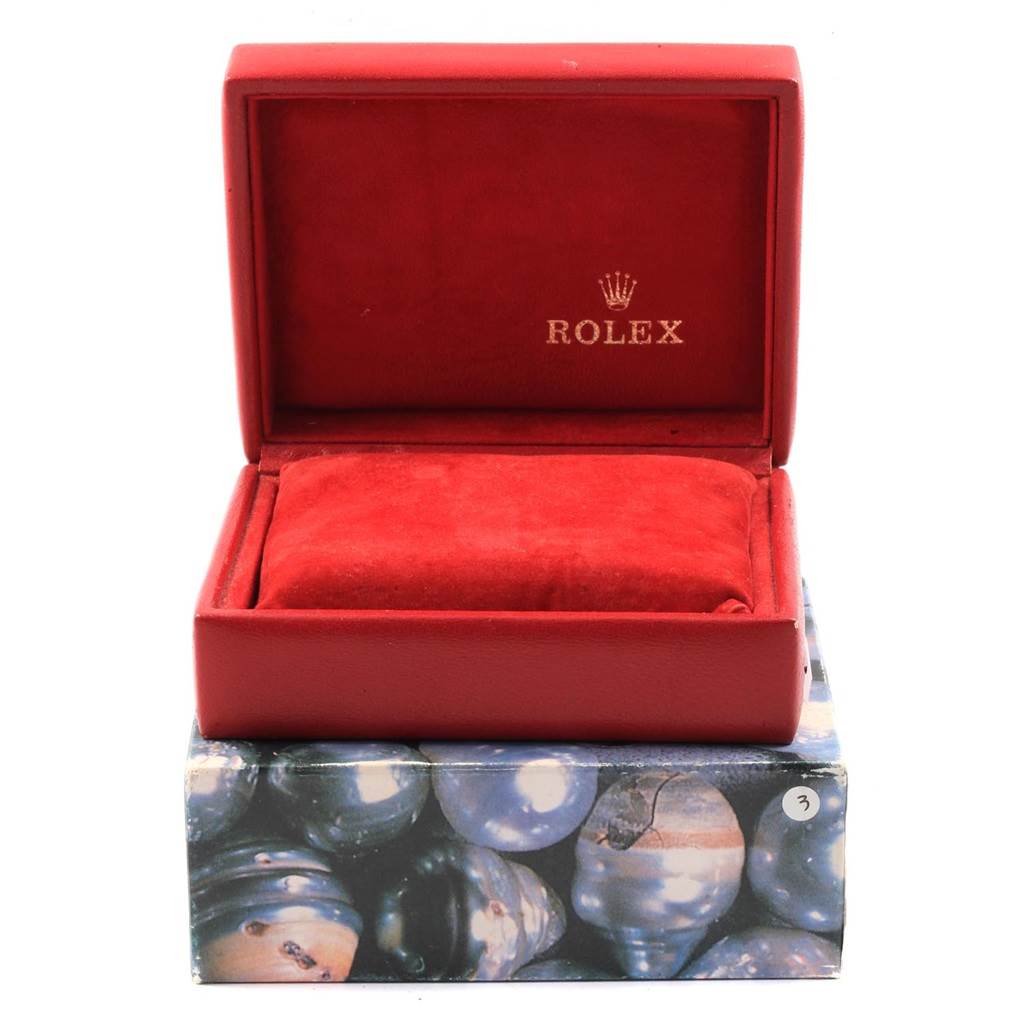 This image shows an open red Rolex watch box, likely for a Mid-Size model, resting on a decorated outer box.