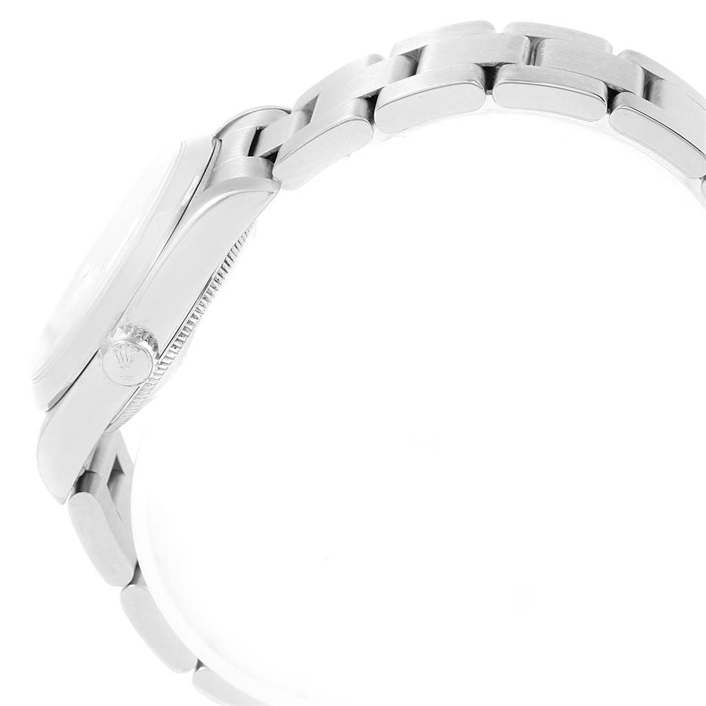 The image shows a side view of a Mid-Size Rolex watch, focusing on the case, crown, and part of the bracelet.