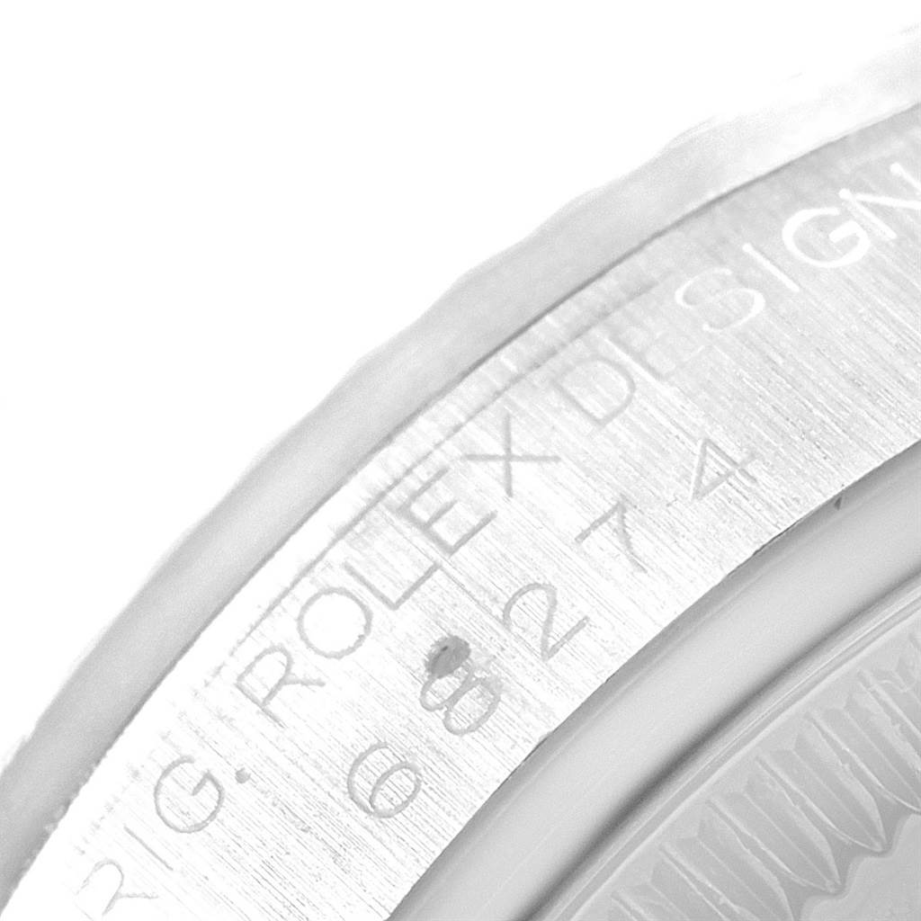 This image shows a close-up of the engraved bezel on a Rolex Mid-Size 68274 Women
s Stainless Steel Blue Dial 68274 Women
s Stainless Steel Blue Dial model watch.