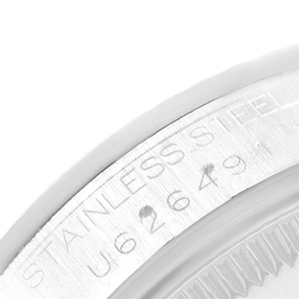 This image shows a close-up of the serial number engraving on the stainless steel case of a Mid-Size Rolex watch.