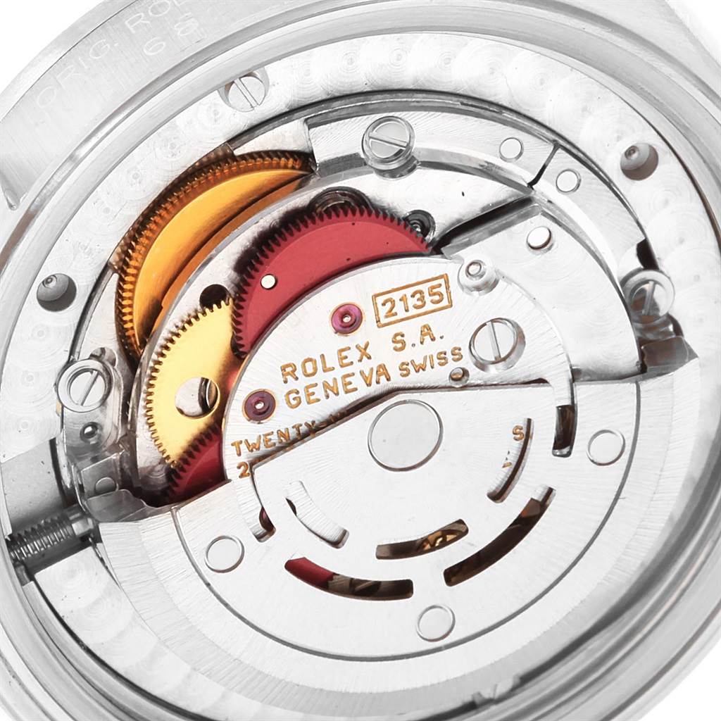 The image shows a close-up view of the internal movement mechanism of a Rolex Mid-Size 68274 Women
s Stainless Steel Blue Dial 68274 Women
s Stainless Steel Blue Dial watch, Model 2135.