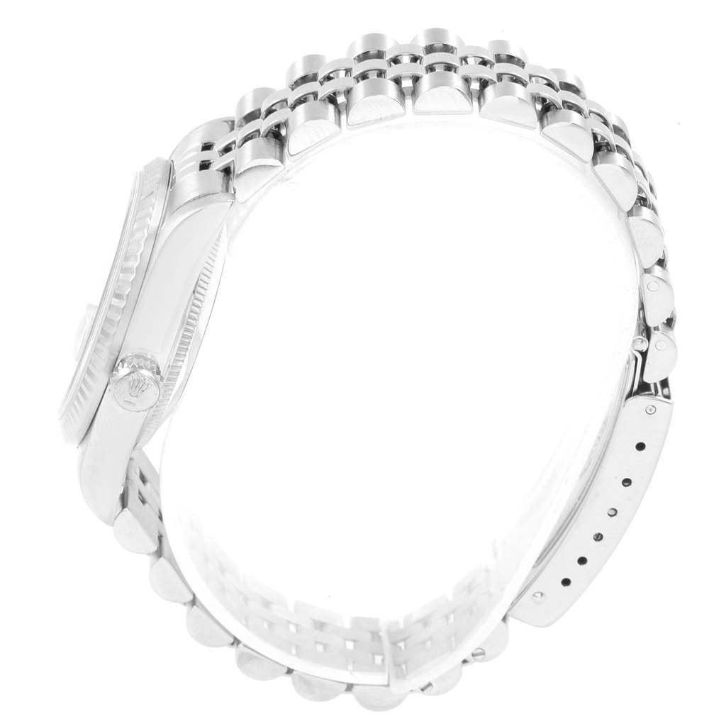 The image shows a side view of the Mid-Size Rolex watch highlighting the bracelet and crown.