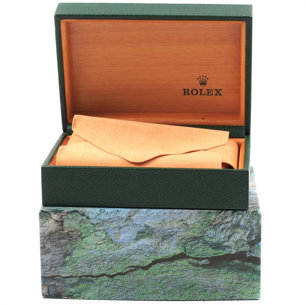 The image shows an open Rolex watch box for a Mid-Size model, revealing a cushion but not the watch itself.