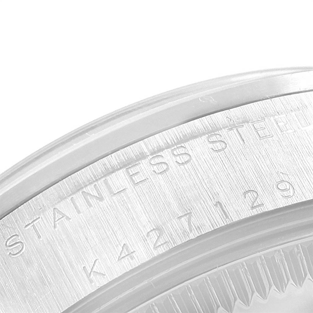This image shows a close-up of the stainless steel case back of a Rolex Mid-Size 78240 Women's Stainless Steel Silver Dial 78240 Women's Stainless Steel Silver Dial watch, displaying part of its serial number.