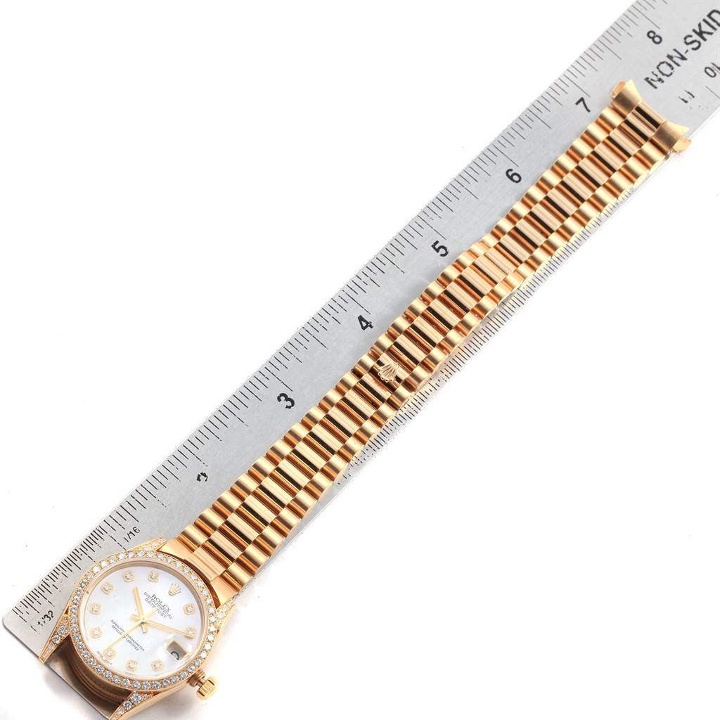 The image shows a top-down view of a Rolex Mid-Size 78158 Women's Yellow Gold Mother of Pearl Dial 78158 Women's Yellow Gold Mother of Pearl Dial watch face and its bracelet next to a ruler for scale.