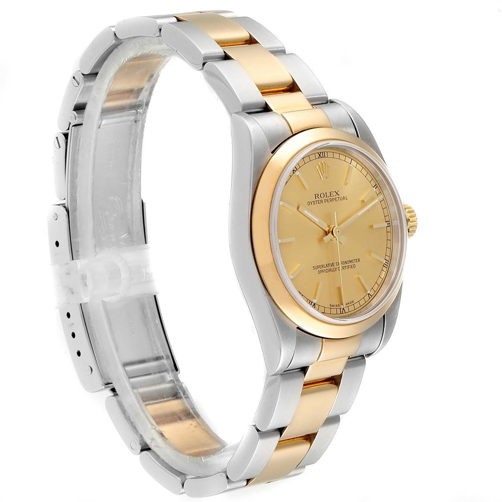 The image shows a side angle of a Rolex Mid-Size 20548 Women
s Steel and Gold (two tone) Champagne Dial 20548 Women
s Steel and Gold (two tone) Champagne Dial Oyster Perpetual watch highlighting the face, bezel, and two-tone bracelet.