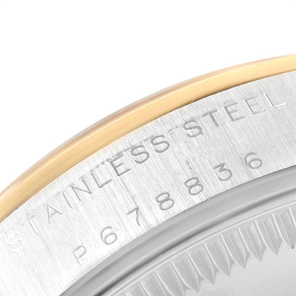 The image shows a close-up view of the case back and edge bezel of a Mid-Size Rolex watch, highlighting the "STAINLESS STEEL" engraving.